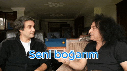 two men sitting next to each other with the words seni bogarm written in blue