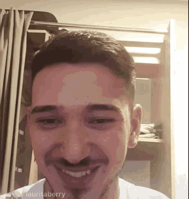 a close up of a man 's face with the name lauritaberry visible