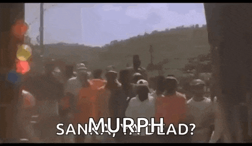 a group of people are walking down a street with the words `` san murphhad '' written on the bottom .