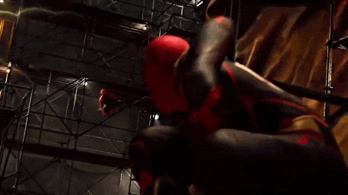 a man in a spiderman costume is flying through the air while a lightning bolt strikes .