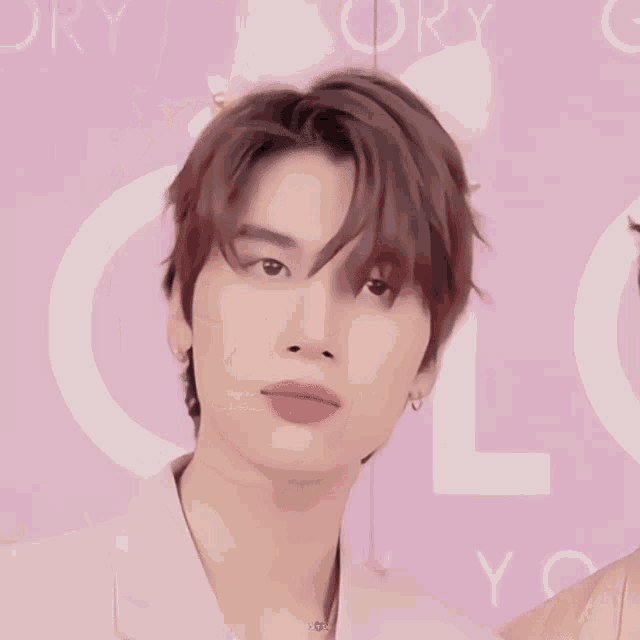a close up of a person 's face in front of a sign that says glory on it