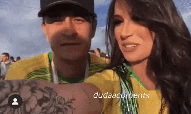 a man and a woman are posing for a picture and the caption reads dudaacomments