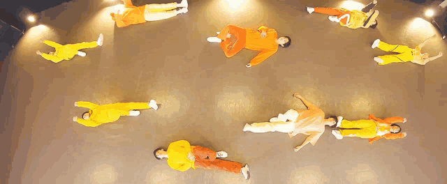 a group of people laying on their stomachs in a circle