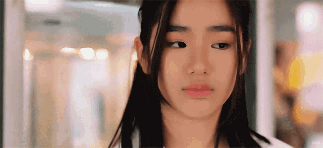 a close up of a girl 's face with a blurry background and the word ' hong ' on the bottom right