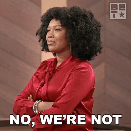 a woman in a red shirt with her arms crossed says " no we 're not "