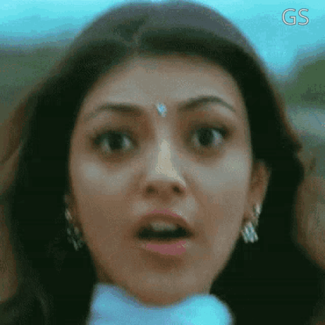 a close up of a woman 's face with a surprised expression .