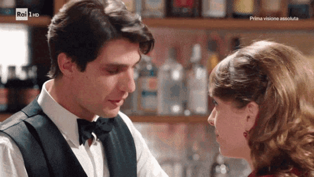 a man and a woman are looking into each other 's eyes in front of a rai hd sign