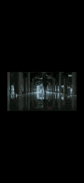 a dark hallway with a sbs logo on the bottom