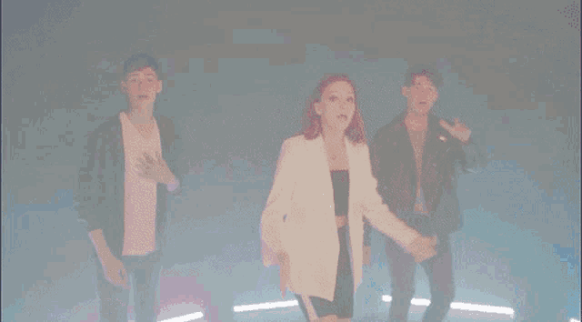 a woman in a white jacket is surrounded by two men in black jackets