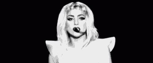 a black and white photo of a woman making a middle finger gesture .