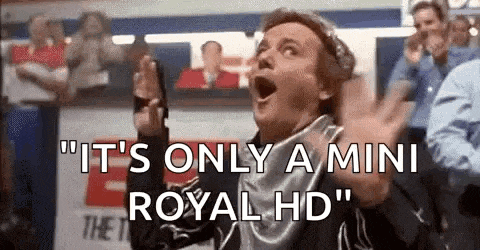 a man is standing in front of a crowd with his mouth open and saying `` it 's only a mini royal hd `` .