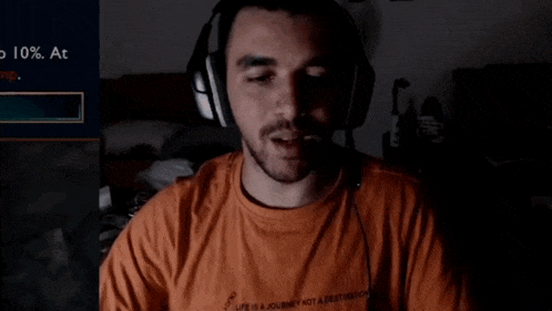 a man wearing headphones is wearing an orange shirt that says life is a journey not a destination