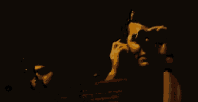 a man talking on a cell phone while another man looks through binoculars .
