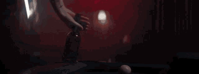 a man is kneeling down next to a woman in a dark room .