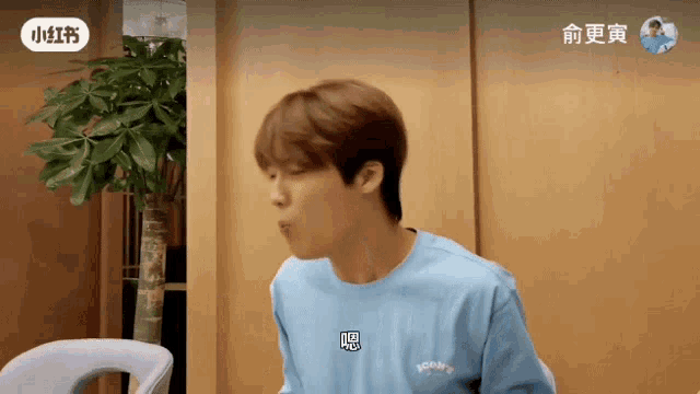 a man wearing a blue shirt that says yours