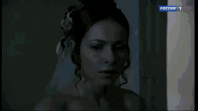 a woman with a flower in her hair is being shown on a television screen with the number 1