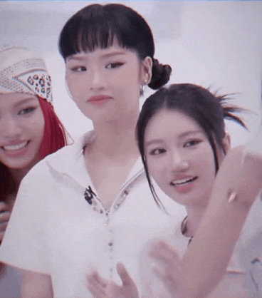 three women are posing for a picture and one of them is wearing a bandana
