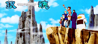a group of people standing on top of a cliff with the words the movie written above them