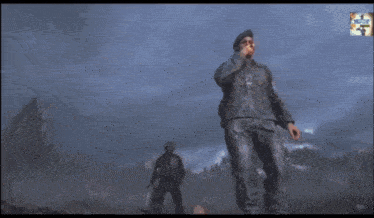 a man in a military uniform stands in front of a large fire