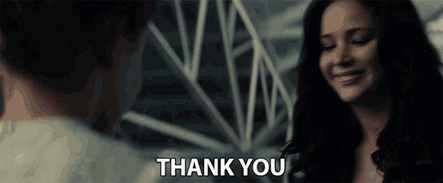 a woman is smiling and says thank you
