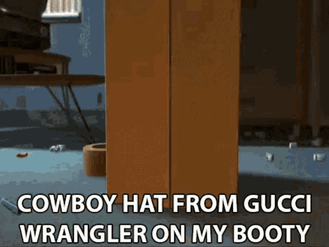 a cowboy hat from gucci wrangler on my booty is on a wooden shelf