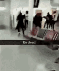 a group of people are standing in a hallway with a sign that says en direct
