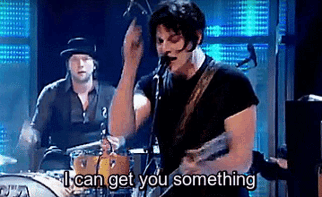 a man singing into a microphone while playing a guitar with the words " i can get you something " next to him .