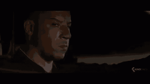 a close up of a man 's face in a dark room in a movie .