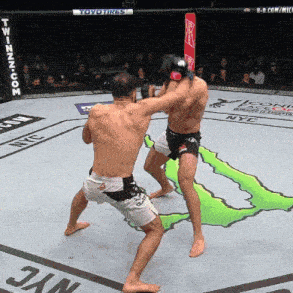 two men are fighting in a boxing ring with a monster logo in the background