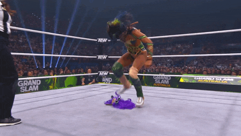 a woman in a wrestling ring with the words grand slam australia behind her