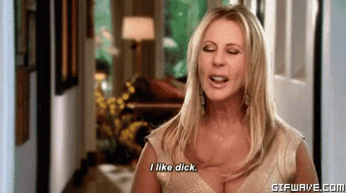 a woman in a gold dress is standing in a hallway and saying `` i like dick '' .