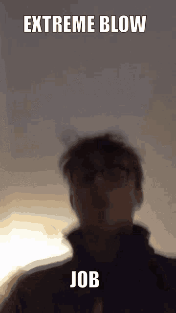 a blurry picture of a man 's face with the words `` extreme blow job '' written above him .