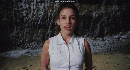 a woman in a white shirt is standing in front of a screen that says www.bandicam.com on it