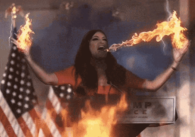 a woman with flames coming out of her mouth is standing in front of an american flag