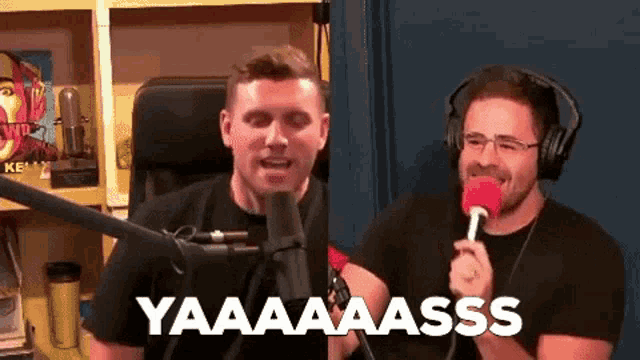 two men are sitting in front of microphones and one of them is holding a microphone and saying yaaaa ass .