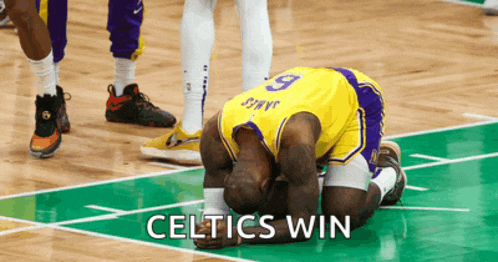 a basketball player with the number 9 on his jersey kneeling down