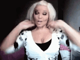 a woman with blonde hair is wearing a black and white shirt