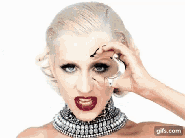 a group of women are dancing on a stage with a gifs.com icon in the lower right corner