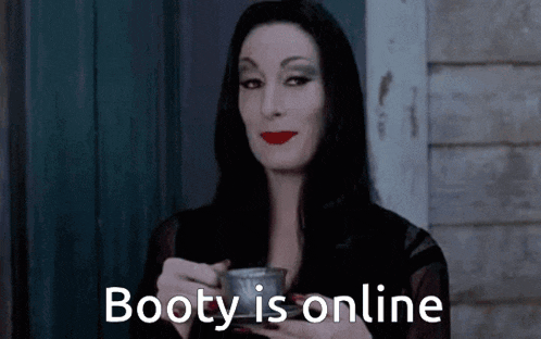 a woman holding a cup of coffee with the words booty is online written on it