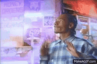 a man in a plaid shirt is standing in front of a sign that says ' snoop dogg '