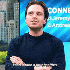 a man with his arms crossed says yeah i take a lot of selfies .