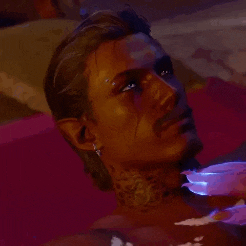 a man with a tattoo on his neck is laying in a bathtub with his eyes closed .