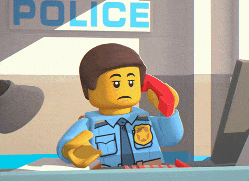 a lego police officer talking on a red phone