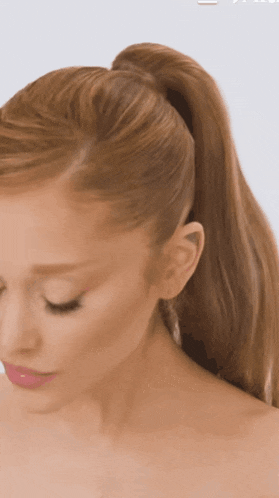 a woman with long hair in a ponytail