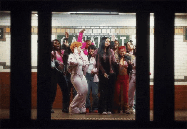 a group of women are standing in front of a sign that says ' a ' on it