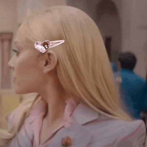 a close up of a woman 's hair with a hello kitty hair clip