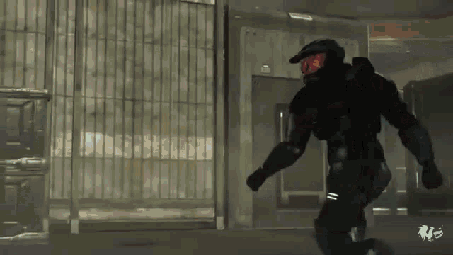 a man in a black suit is running in a room