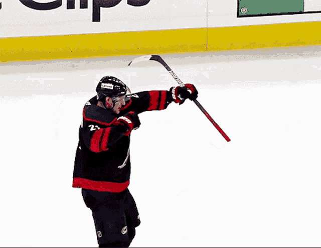 a hockey player wearing a jersey with the letter b on the front