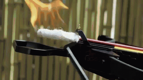 a crossbow with a flame coming out of the barrel