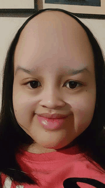 a girl with a very large head wearing a red shirt that says s on it
